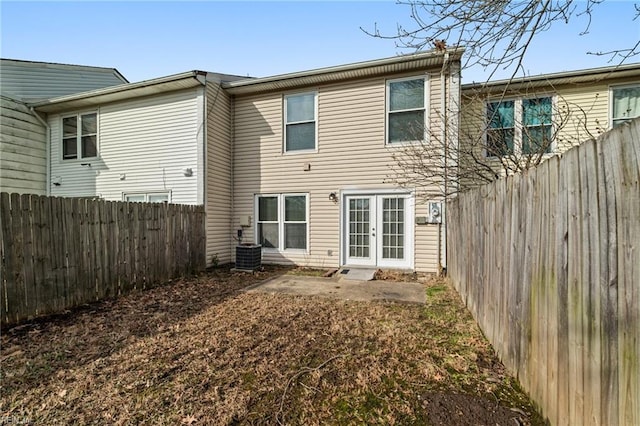 rear view of house with a patio, central AC unit, and french doors