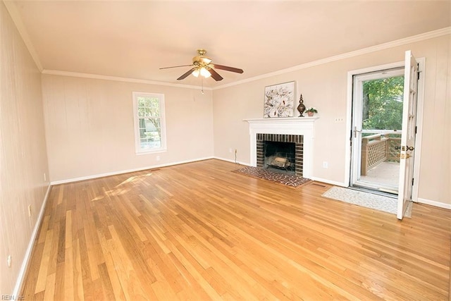 unfurnished living room with a brick fireplace, ornamental molding, and light hardwood / wood-style floors