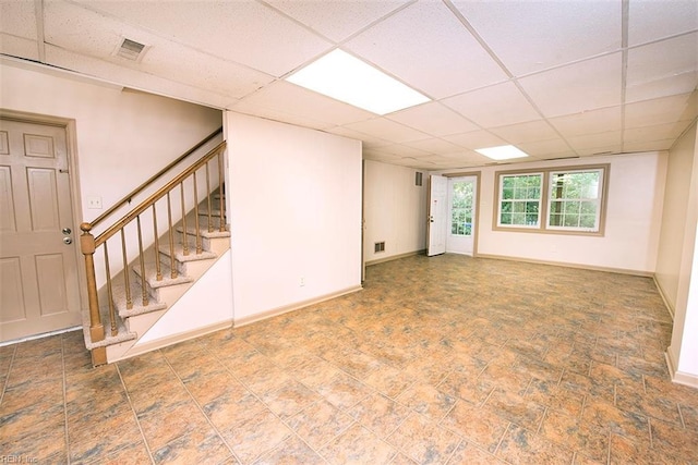 basement featuring a paneled ceiling