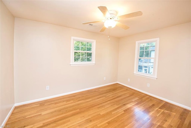 empty room featuring ceiling fan and light wood-type flooring