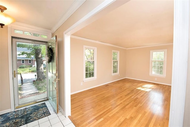 foyer entrance featuring crown molding and light hardwood / wood-style floors