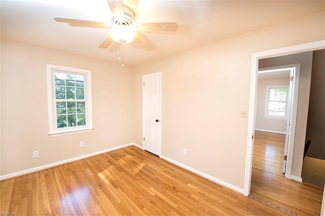 spare room with ceiling fan and light wood-type flooring