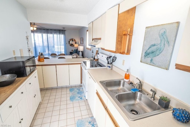 kitchen with sink, white cabinetry, light tile patterned floors, white electric stove, and kitchen peninsula