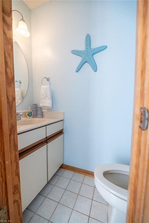 bathroom with vanity, toilet, and tile patterned flooring