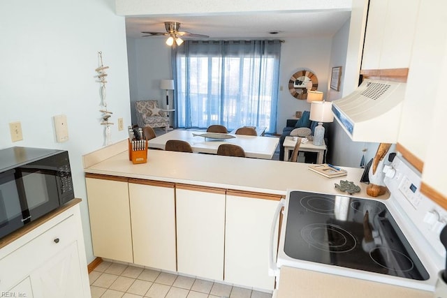 kitchen with kitchen peninsula, white cabinets, ceiling fan, and electric stove