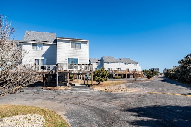 rear view of house with a wooden deck and a carport