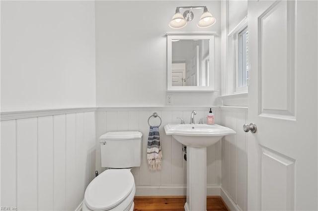 bathroom with sink, hardwood / wood-style floors, and toilet