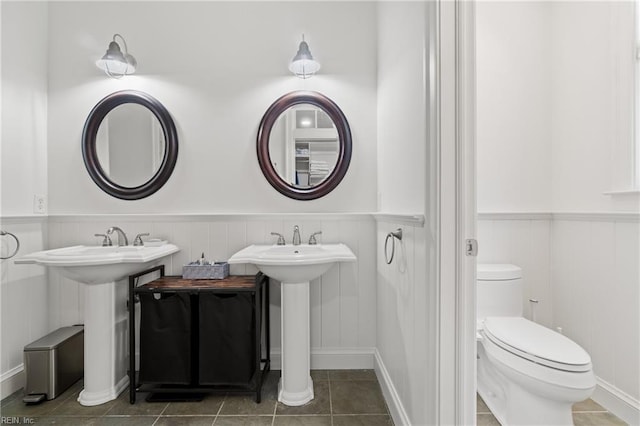 bathroom featuring toilet and tile patterned flooring