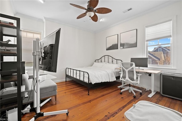 bedroom with crown molding and wood-type flooring