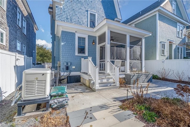 rear view of property with a patio area and a sunroom