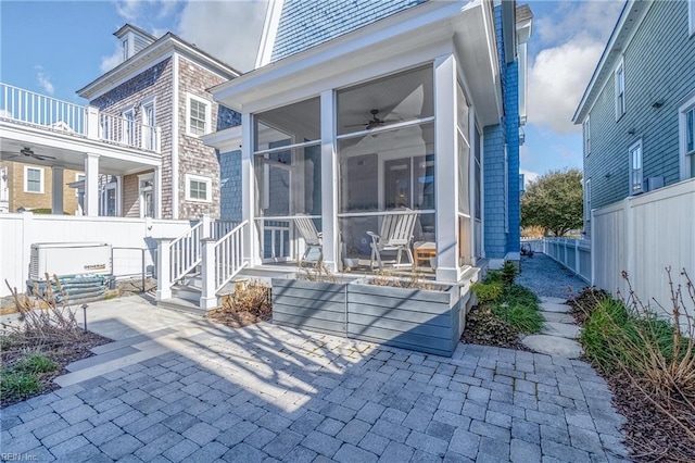 rear view of house with a patio area, a sunroom, and ceiling fan