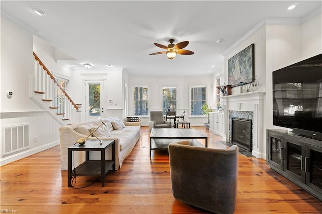 living room featuring ceiling fan, ornamental molding, and hardwood / wood-style floors