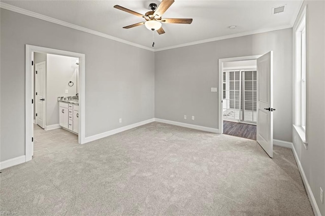 unfurnished bedroom with crown molding, light colored carpet, ceiling fan, and ensuite bathroom