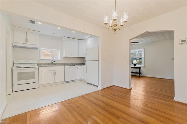 kitchen with white cabinetry, white appliances, light hardwood / wood-style floors, and a healthy amount of sunlight