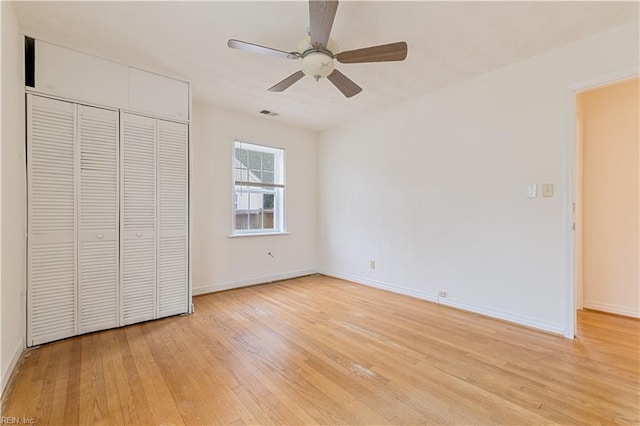 unfurnished bedroom featuring a closet, ceiling fan, and light wood-type flooring