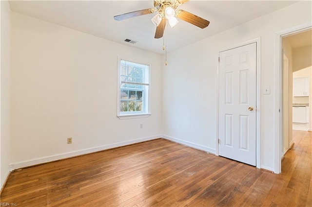 unfurnished bedroom with ceiling fan and wood-type flooring