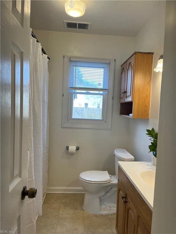 bathroom with vanity, tile patterned flooring, a shower with curtain, and toilet