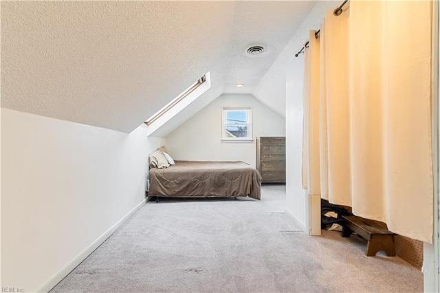 carpeted bedroom featuring lofted ceiling and a textured ceiling