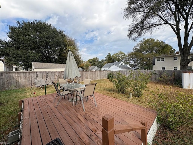 wooden deck featuring a yard