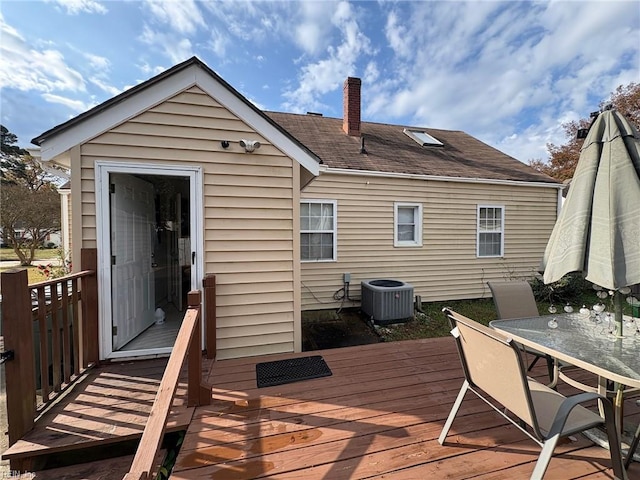 rear view of property featuring cooling unit and a deck