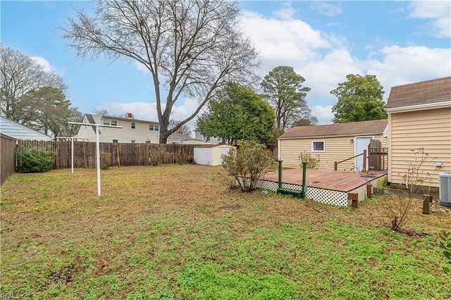 view of yard featuring cooling unit and a deck