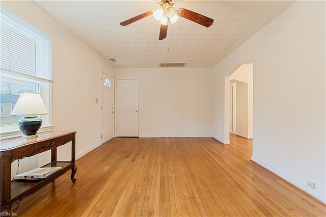 spare room with light hardwood / wood-style flooring and ceiling fan