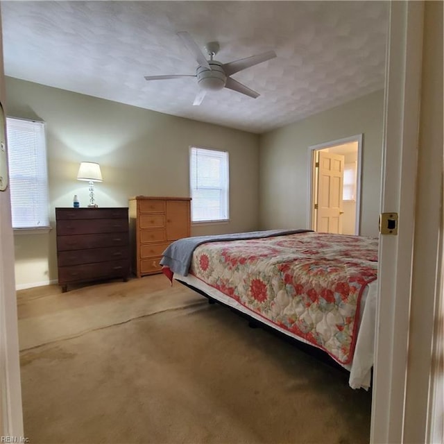 bedroom with ceiling fan and carpet floors