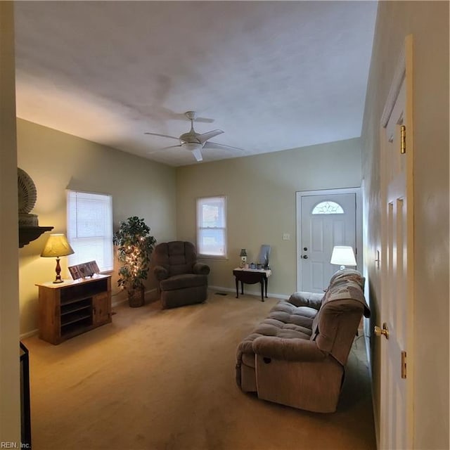 living room featuring light carpet and ceiling fan