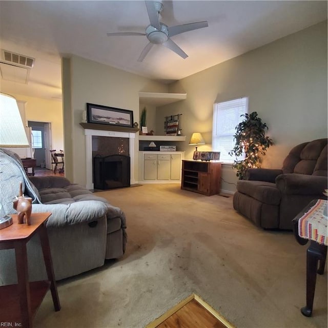 living room featuring light colored carpet and ceiling fan