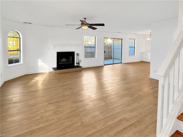 unfurnished living room with ceiling fan and light hardwood / wood-style flooring