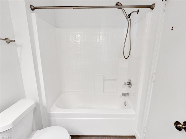 bathroom with washtub / shower combination and toilet