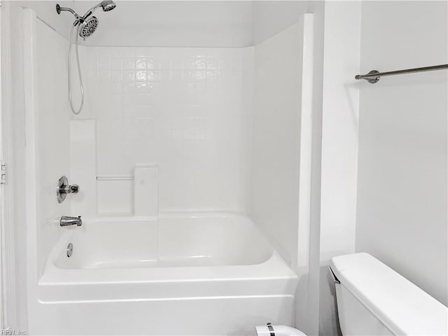 bathroom with toilet and shower / bathing tub combination