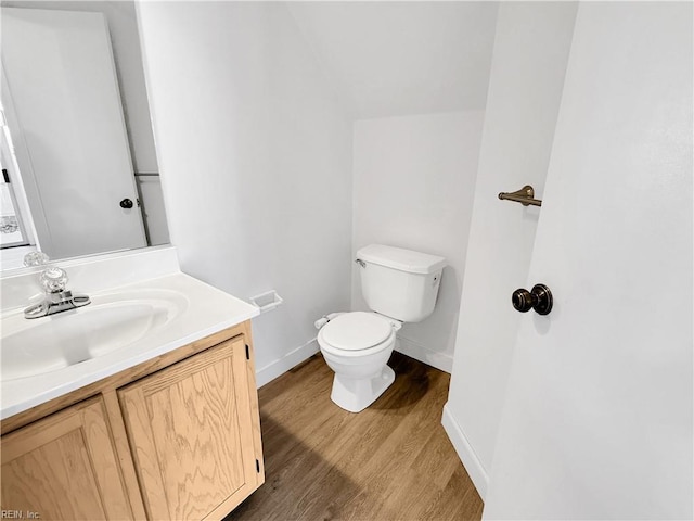 bathroom with vanity, wood-type flooring, and toilet