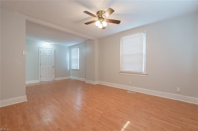 spare room with ceiling fan and light wood-type flooring