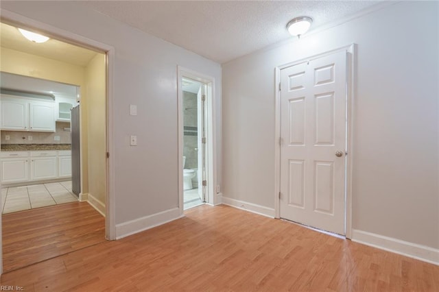 interior space featuring a textured ceiling and light wood-type flooring