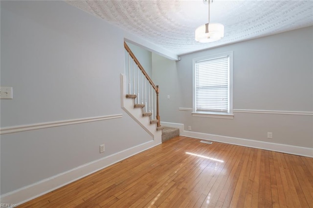 interior space with hardwood / wood-style floors and a textured ceiling