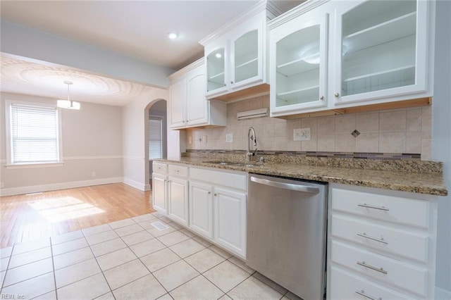 kitchen with white cabinetry, sink, dark stone countertops, and dishwasher