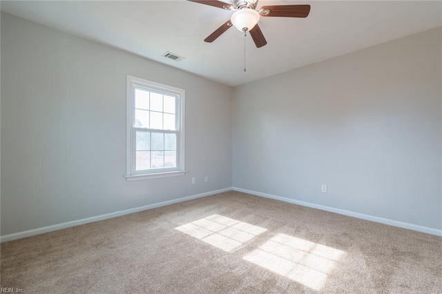 carpeted spare room with ceiling fan