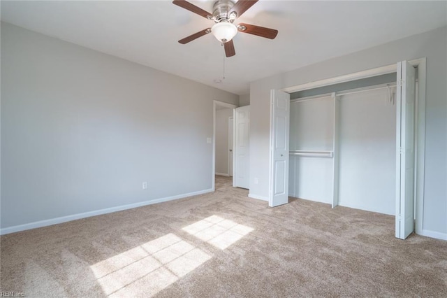 unfurnished bedroom with ceiling fan, light colored carpet, and a closet