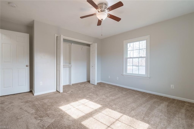 unfurnished bedroom with light carpet, a closet, and ceiling fan