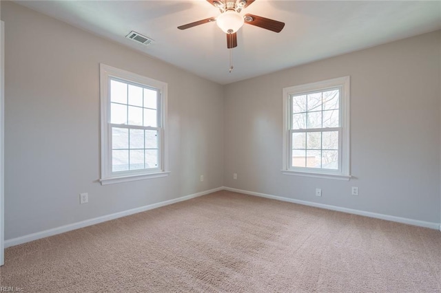 spare room with carpet floors and ceiling fan