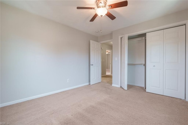 unfurnished bedroom with light colored carpet, a closet, and ceiling fan