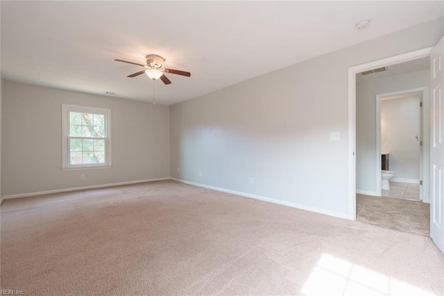 empty room with ceiling fan and light carpet