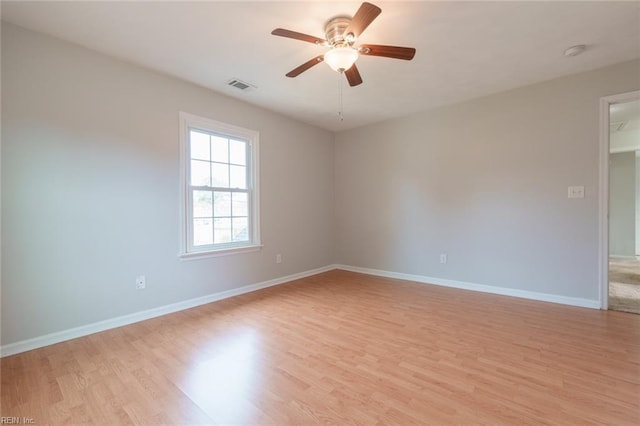 spare room with ceiling fan and light wood-type flooring