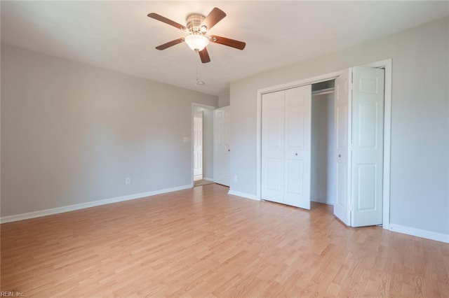 unfurnished bedroom featuring ceiling fan, light wood-type flooring, and a closet