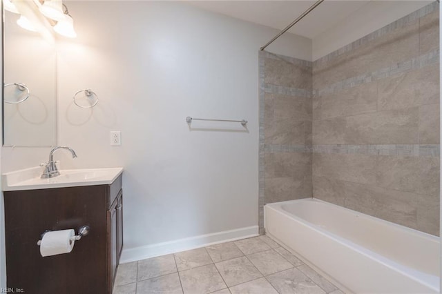 bathroom featuring tiled shower / bath combo, vanity, and tile patterned flooring