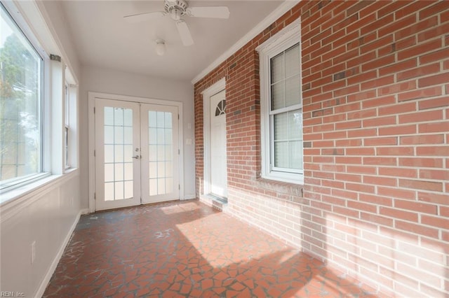 unfurnished sunroom featuring french doors and ceiling fan