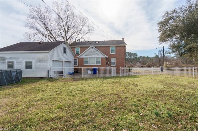 rear view of property featuring a yard and a garage