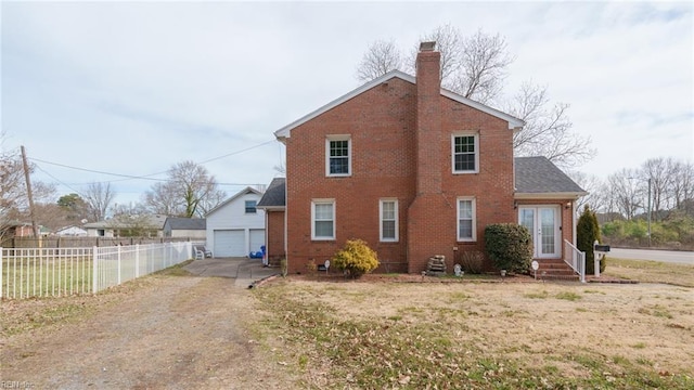 view of home's exterior with an outbuilding, a yard, and a garage