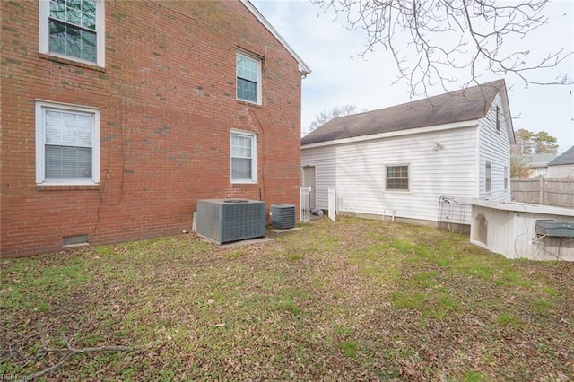 back of property featuring a yard and cooling unit